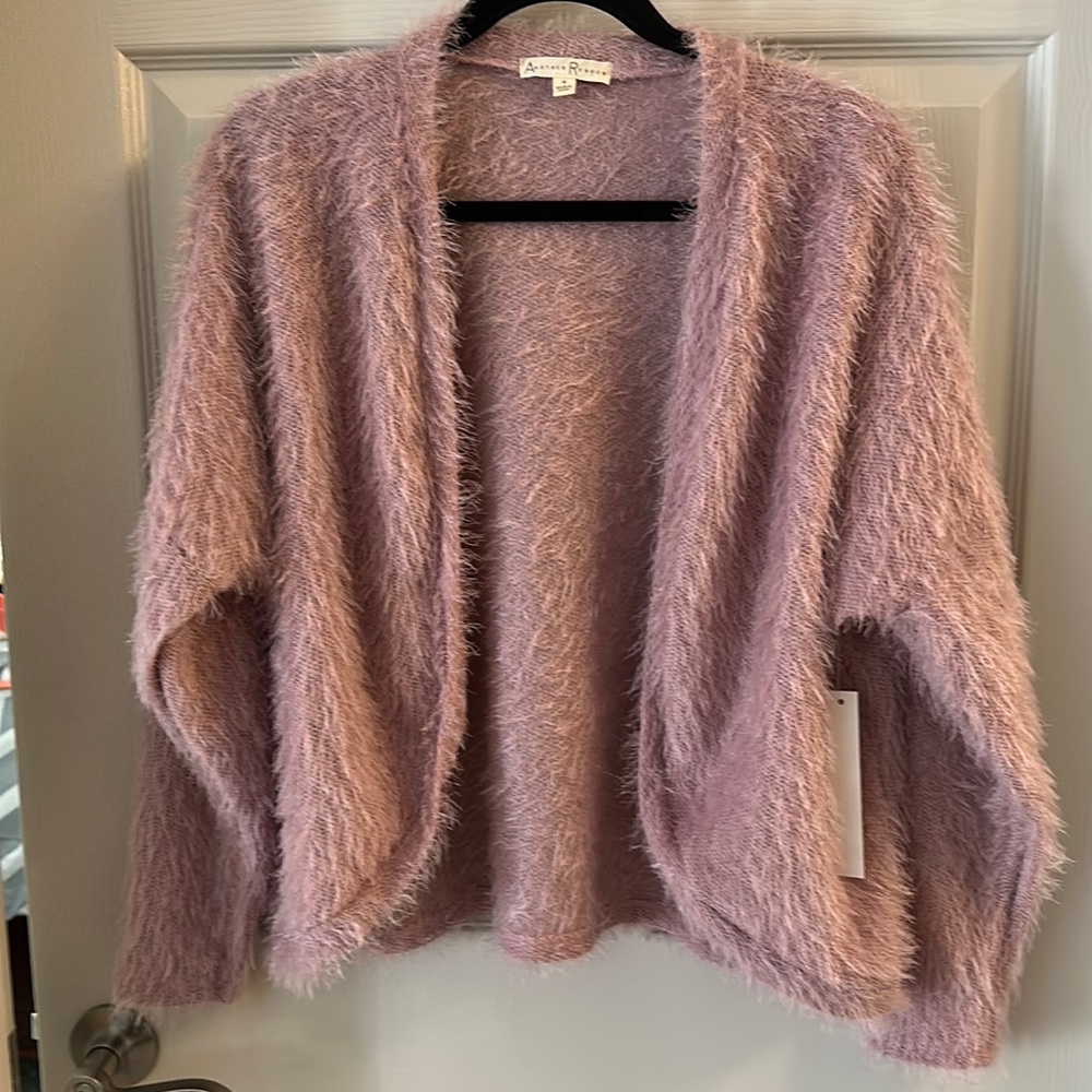 Pink fuzzy sweater.